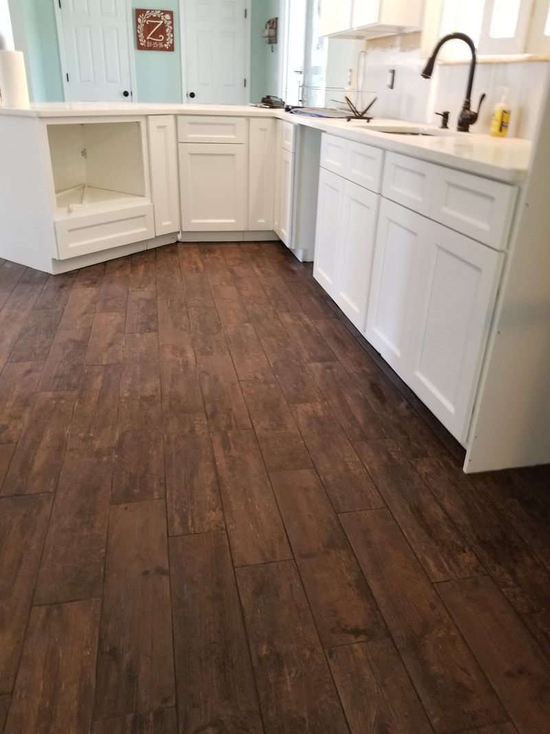 Wood-look flooring install with dark grout