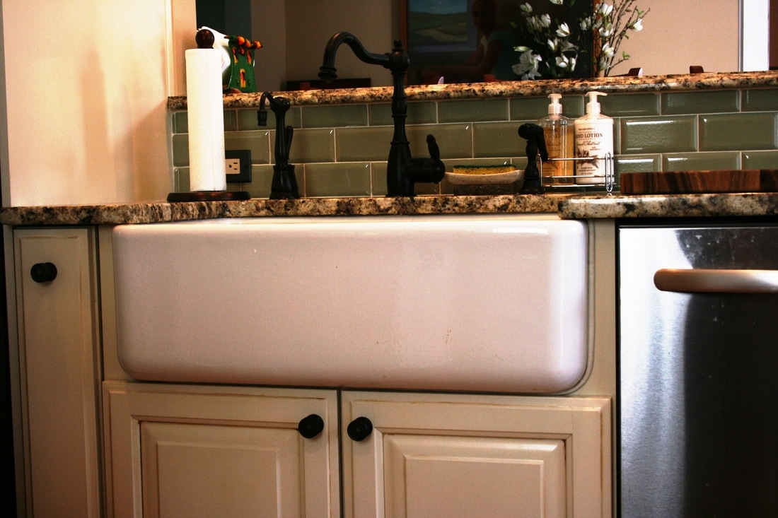 Kitchen remodel, farm sink, glass tile, cream cabinets, oil rubbed bronze