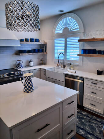 Kitchen remodel with granite, stainless steel, white cabinets and hardwood flooring
