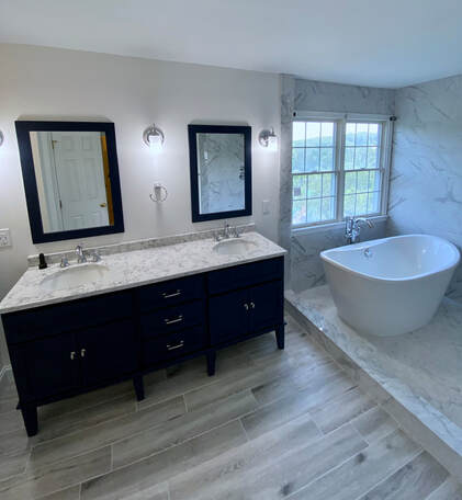 PictureBathroom remodel with free standing bathtub and white marble tile. 